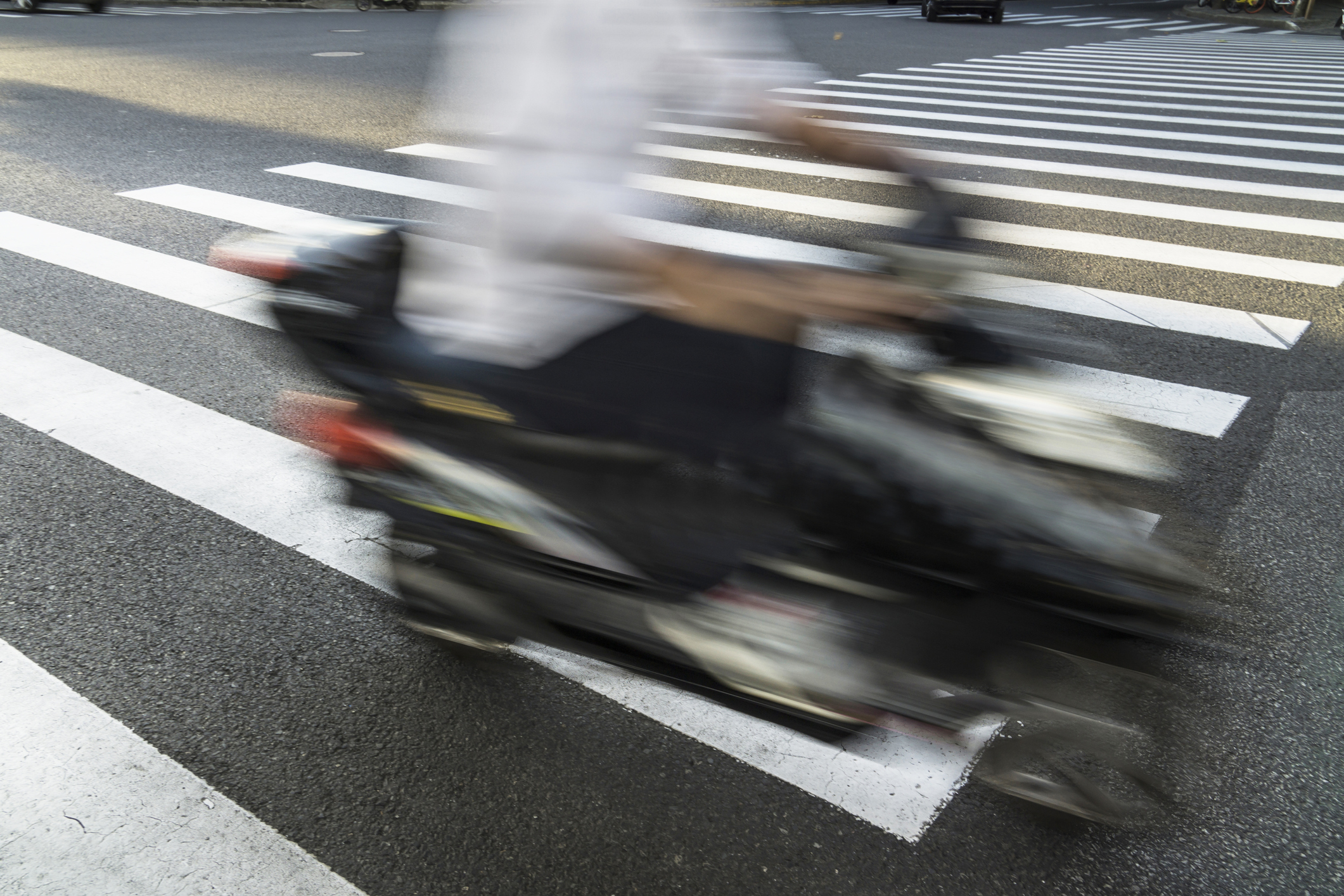 A man ride a electric bicycle across the zebra crossing,China - East Asia,