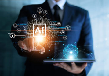 Businessman touching the brain working of Artificial Intelligence (AI) in the futuristic business and coding software development on interface and synchronize network connection, IoT, innovative and technology of business.