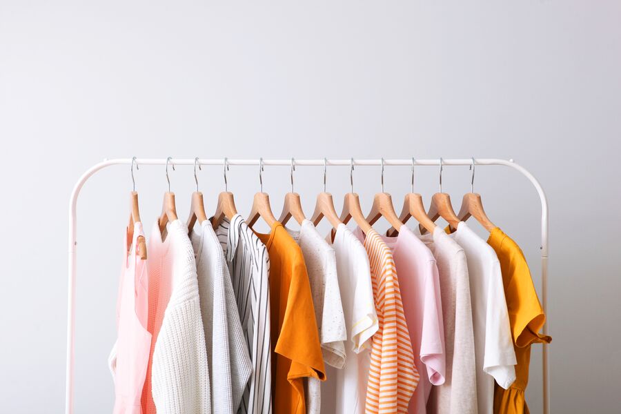 Fashion-clothes-on-a-rack-GettyImages-1257563298-Med